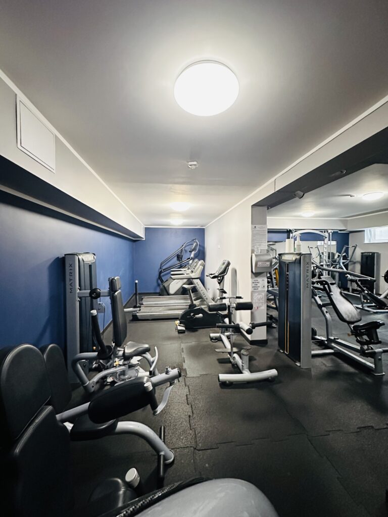 Na zdjęciu przedstawione jest wnętrze sali ćwiczeń razem ze sprzętem do ćwiczenia.